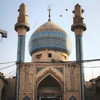 An exterior view of a mosque with a blue tile dome, intricate details, and two minarets. The mosque is a symbol of Islamic architecture and culture.