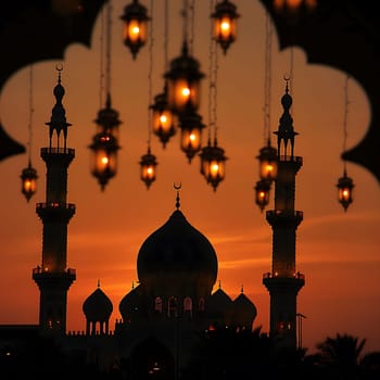 A silhouette of a mosque against a sunset sky. The mosque's minarets and dome are visible against the golden light.