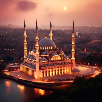 A grand mosque illuminated at sunset with a cityscape in the background.