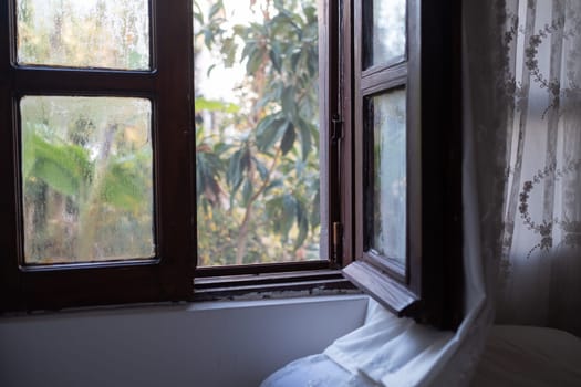 Bright morning sun in the open window through the curtains. High quality photo