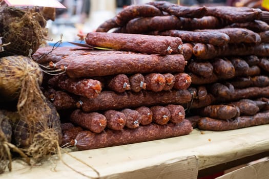 Smoked homemade sausages at the outdoors farmers market. close up view