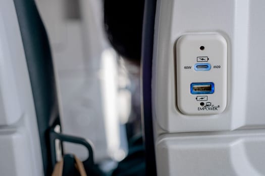 Close up USB port at the seat of airplane for charging the electronics devices while traveling.