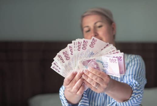 a large fan of 200 Turkish lira in the hands of a tourist in Turkey, a lot of money for shopping, entertainment and travel,