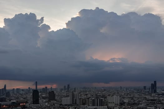 Bangkok, Thailand - 28 May 2024 - Beautiful clouds in the sky over large metropolitan city of bangkok. Aerial view of skyscrapers and dramatic sky before sunset, Copy space, Selective focus.