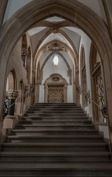 Munich, Germany - Dec 21, 2023 - Gothic architectural style with arches of famous New Town Hall (Neues Rathaus) on Marienplatz square in Munich. Beautiful Corridor with Staircase, Ceiling, Pillars and Lamp, Copy space, Selective focus.