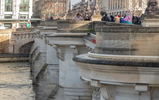 France, Paris - Jan 03, 2024 - Detail of Round bastions which give it the look of a castle and ornate gargoyles are humorous, grotesque figures of dentists, pickpockets and loiterers on the Pont Neuf bridge. Space for text, Selective focus.