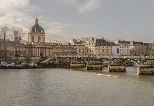 France, Paris - Jan 03, 2024 - Pont des arts (Passerelle des arts) is a pedestrian bridge which across the seine river to The Institut de France in Paris. Copy space, Selective focus.
