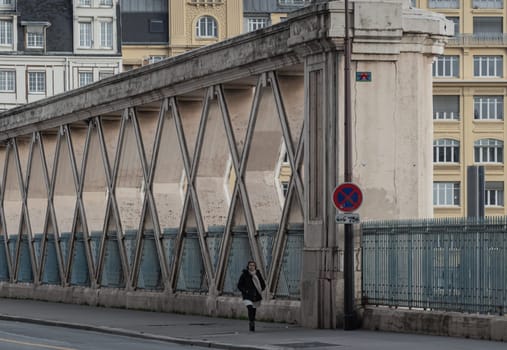 France, Paris - Jan 03, 2024 - People walking along a Bridge on Rue La Fayette. Bridge built above the railways of gare de l'Est, Pont de Lafayette, Rue de l'Aqueduc, Space for text, Selective focus.