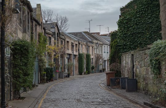 Edinburgh, Scotland - Jan 16, 2024 - Perspective view of Circus Lane is a picturesque cobbled street in Stockbridge of Edinburgh, This residential street with pretty flower-covered terraced mews houses. Copy space, Selective focus.