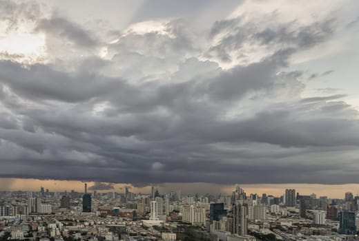 Bangkok, Thailand - 20 Jun, 2024 - Aerial view of skyscrapers and dramatic sky before sunset. Beautiful clouds in the sky over large metropolitan city of bangkok, Copy space, Selective focus.