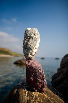 balanced stones on the rocks of the sea