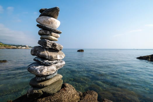 balanced stones on the rocks of the sea