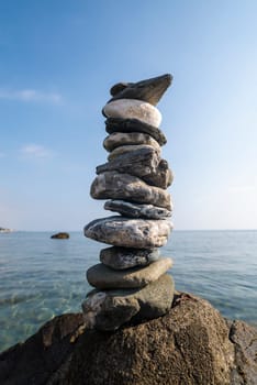 balanced stones on the rocks of the sea