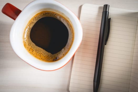 A pen A notebook and a cup of coffee. Background for ideas or inspiration.