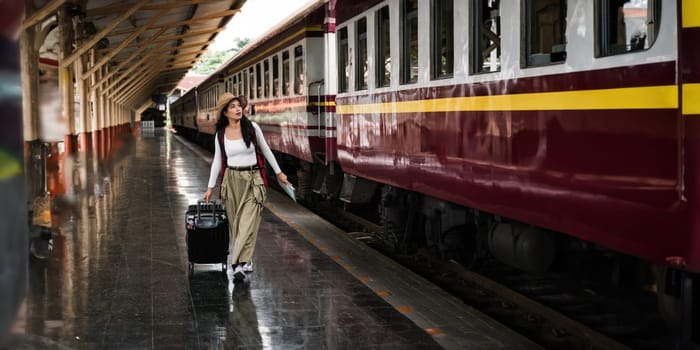 Young woman with suitcase for tourist adventure holiday traveling with a train.concept transport lifestyle active journey and travel lifestyle travel.