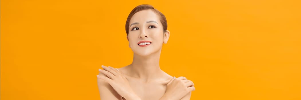 Young lovely woman is touching her shoulder. Web banner