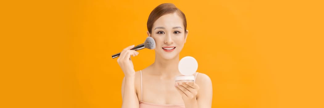 Banner of Beautiful girl doing contouring apply blush on cheeks.