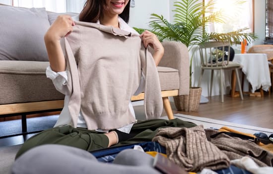 Woman packs things in preparation for a holiday, preparing things for a weekend trip..