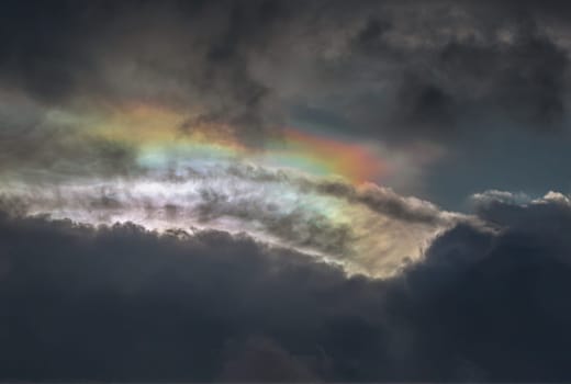 The sun's rays passing through the clouds and shining form an interesting light pattern against the sky. Amazing colors sky and clouds for background wallpaper and texture, Nature abstract composition, Selective focus.