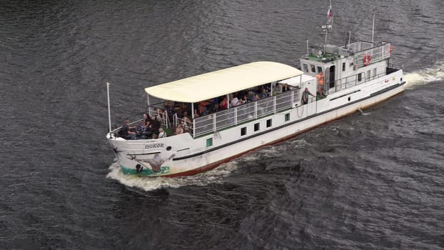 Russia, Pskov, July 19, 2024 - A group of passengers enjoy a leisurely boat ride on the river