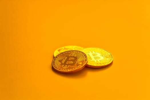 Three yellow bitcoin beans laying on flat surface.