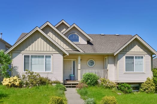 Average residential house in Canada on blue sky background.