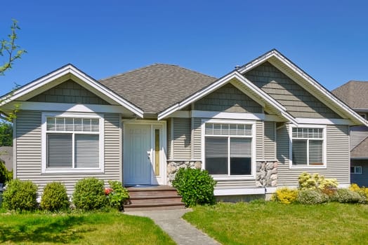 Average residential house in Canada on blue sky background.