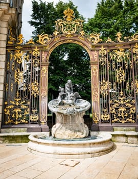 Gates and fountains in Stanislas Place - Nancy - France. One of the ornate gates and fountains in Stanislas Place in the historic center of the city of Nancy in France. A UNESCO World Heritage Site