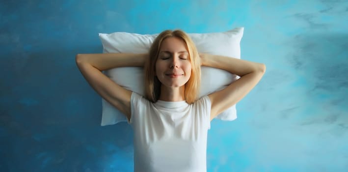 Healthy sleep, happy relaxed sleepy young woman on white soft comfortable pillow imagining that she is lying on the bed
