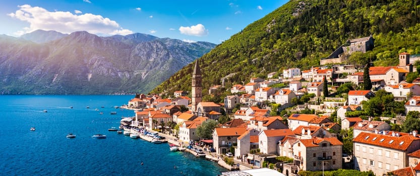 View of the historic town of Perast at famous Bay of Kotor on a beautiful sunny day with blue sky and clouds in summer, Montenegro. Historic city of Perast at Bay of Kotor in summer, Montenegro.