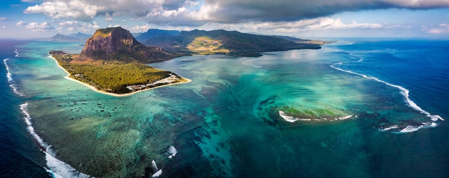 Aerial view of Mauritius island panorama and famous Le Morne Brabant mountain, beautiful blue lagoon and underwater waterfall. Le Morne Brabant peninsula and Underwater Waterfall, Mauritius.