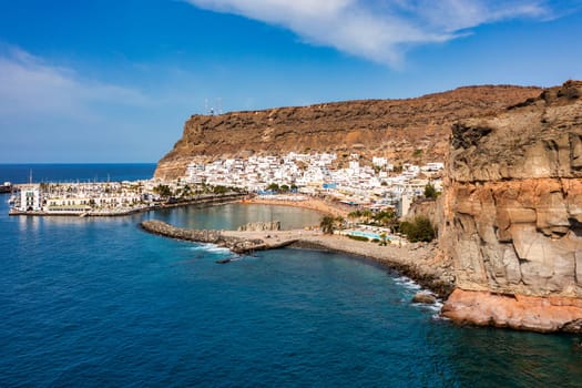 Puerto de Mogan with the beach in Gran Canaria, Spain. Favorite vacation place for tourists and locals on island. Harbor in Puerto de Mogan and Playa Mogan on Grand Canary Island, Spain.