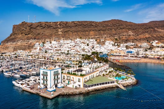 Puerto de Mogan with the beach in Gran Canaria, Spain. Favorite vacation place for tourists and locals on island. Harbor in Puerto de Mogan and Playa Mogan on Grand Canary Island, Spain.