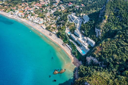 Agios Gordios exotic beach in Corfu island,Greece. Agios Gordios beach, Corfu island, Greece. Panoramic view of the Agios Gordios beach, sandy seashore with beach umbrellas and deck chairs.