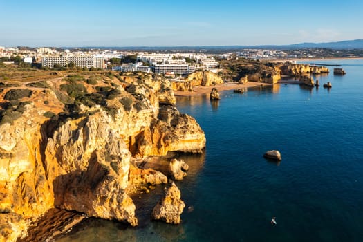 Panoramic view, Ponta da Piedade near Lagos in Algarve, Portugal. Cliff rocks and tourist boat on sea at Ponta da Piedade, Algarve region, Portugal. Ponta da Piedade, Algarve region, Portugal.