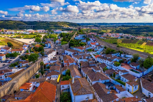 Aerial view of the historic walled town of Obidos at sunset, near Lisbon, Portugal. Aerial shot of Obidos Medieval Town, Portugal. Aerial view of medieval fortress in Obidos. Portugal.