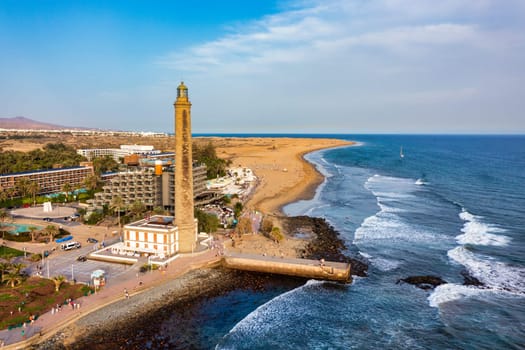 Lighthouse of Maspalomas at Gran Canaria Island known as Faro de Maspalomas at sunset. Seascape with lighthouse and Maspalomas beach. Gran Canaria, Canary Islands, Spain