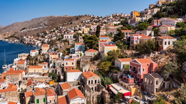 Aerial view of the beautiful greek island of Symi (Simi) with colourful houses and small boats. Greece, Symi island, view of the town of Symi (near Rhodes), Dodecanese.