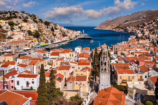 Aerial view of the beautiful greek island of Symi (Simi) with colourful houses and small boats. Greece, Symi island, view of the town of Symi (near Rhodes), Dodecanese.
