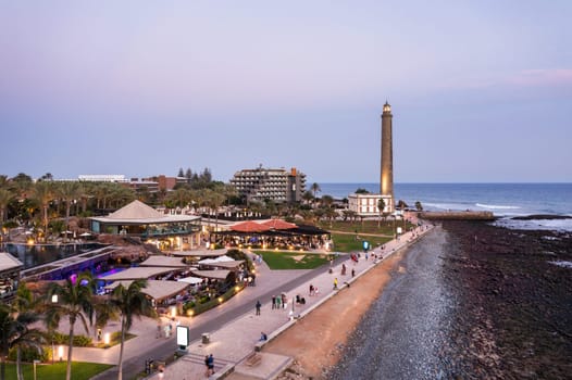 Lighthouse of Maspalomas at Gran Canaria Island known as Faro de Maspalomas at sunset. Seascape with lighthouse and Maspalomas beach. Gran Canaria, Canary Islands, Spain