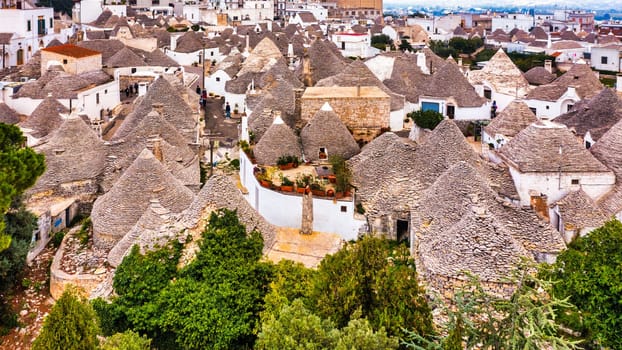 The traditional Trulli houses in Alberobello city, Apulia, Italy. Cityscape over the traditional roofs of the Trulli, original and old houses of this region, Apulia, Alberobello, Puglia, Italy. 