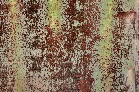 Detailed grunge rusted metal texture. Backdrop of rusty surface of dark, brown, and orange hues. Close-up of rust patterns, aged iron, scratched, worn, distressed areas, decay, corrosion details