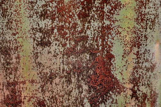 Detailed grunge rusted metal texture. Backdrop of rusty surface of dark, brown, and orange hues. Close-up of rust patterns, aged iron, scratched, worn, distressed areas, decay, corrosion details