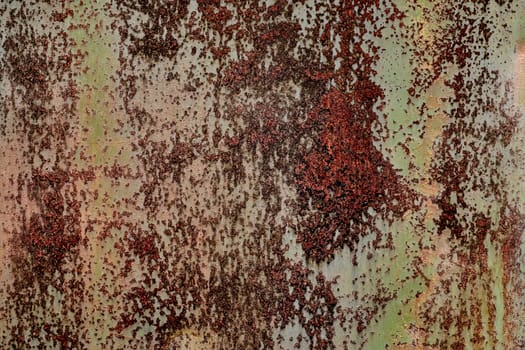 Detailed grunge rusted metal texture. Backdrop of rusty surface of dark, brown, and orange hues. Close-up of rust patterns, aged iron, scratched, worn, distressed areas, decay, corrosion details