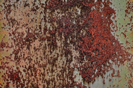 Detailed grunge rusted metal texture. Backdrop of rusty surface of dark, brown, and orange hues. Close-up of rust patterns, aged iron, scratched, worn, distressed areas, decay, corrosion details