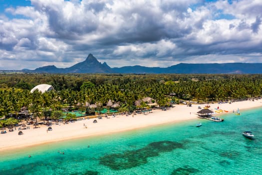 Beach of Flic en Flac with beautiful peaks in the background, Mauritius. Beautiful Mauritius Island with gorgeous beach Flic en Flac, aerial view from drone. Flic en Flac Beach, Mauritius Island.