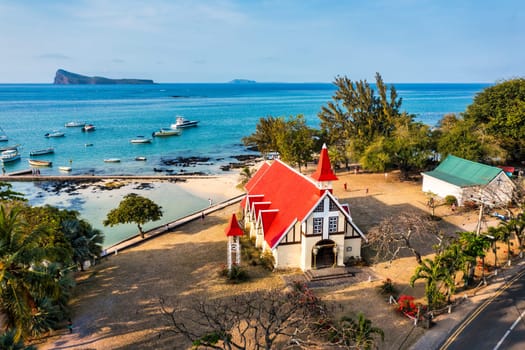 Red church at Cap Malheureux village, Mauritius Island. Notre Dame de Auxiliatrice, rural church with red roof in Cap Malheureux tropical village on Mauritius island, Indian Ocean.