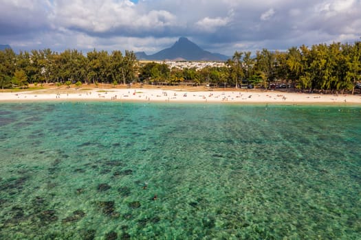 Beach of Flic en Flac with beautiful peaks in the background, Mauritius. Beautiful Mauritius Island with gorgeous beach Flic en Flac, aerial view from drone. Flic en Flac Beach, Mauritius Island.