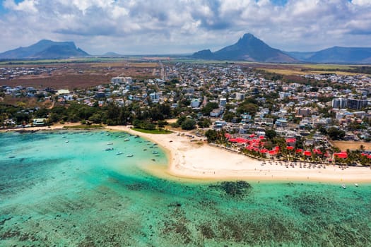Beautiful Mauritius Island with gorgeous beach Flic en Flac, aerial view from drone. Mauritius, Black River, Flic-en-Flac view of oceanside village beach and luxurious hotel in summer.