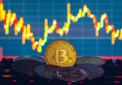 Bitcoin, litecoin and ripple coins currency finance money on graph chart background. Bitcoin as most important cryptocurrency concept. Stack of cryptocurrencies with a golden bitcoin in the middle.